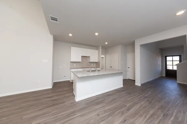 a view of kitchen with sink and wooden floor