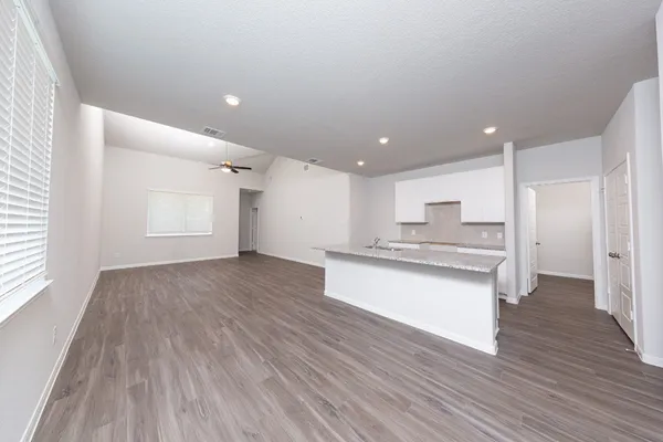 a view of kitchen with wooden floor and electronic appliances