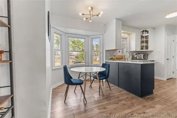 a view of a dining room with furniture window and wooden floor