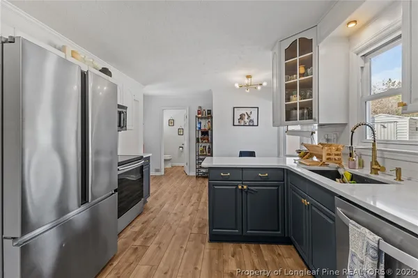 a kitchen with stainless steel appliances a sink stove and refrigerator