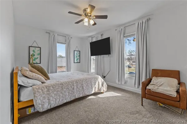 a bedroom with a bed and a couch