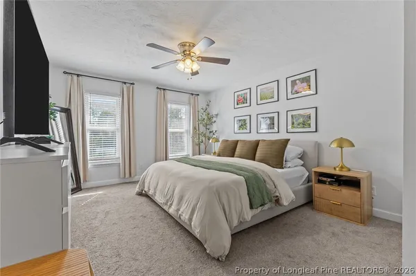a spacious bedroom with a bed and a chandelier
