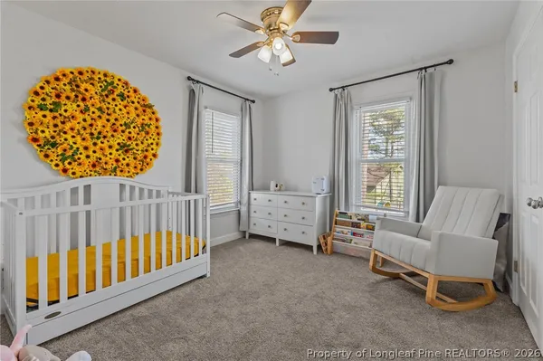 a view of a bedroom with furniture and a window