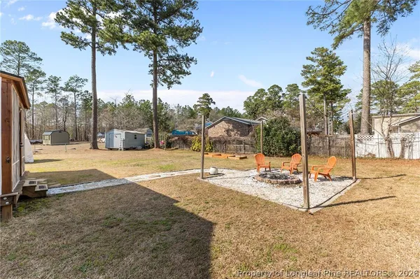 a backyard of a house with table and chairs