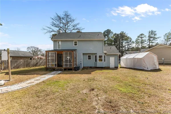 a backyard of a house with table and chairs