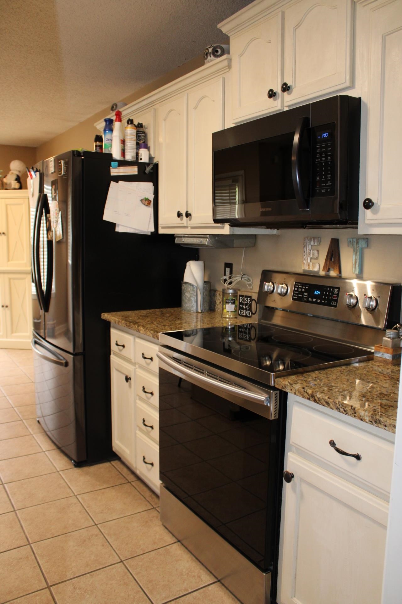 64 Buck Stand Road Atoka, TN 38004 - Photo 17 of 39 a kitchen with stainless steel appliances granite countertop a refrigerator stove top oven and sink