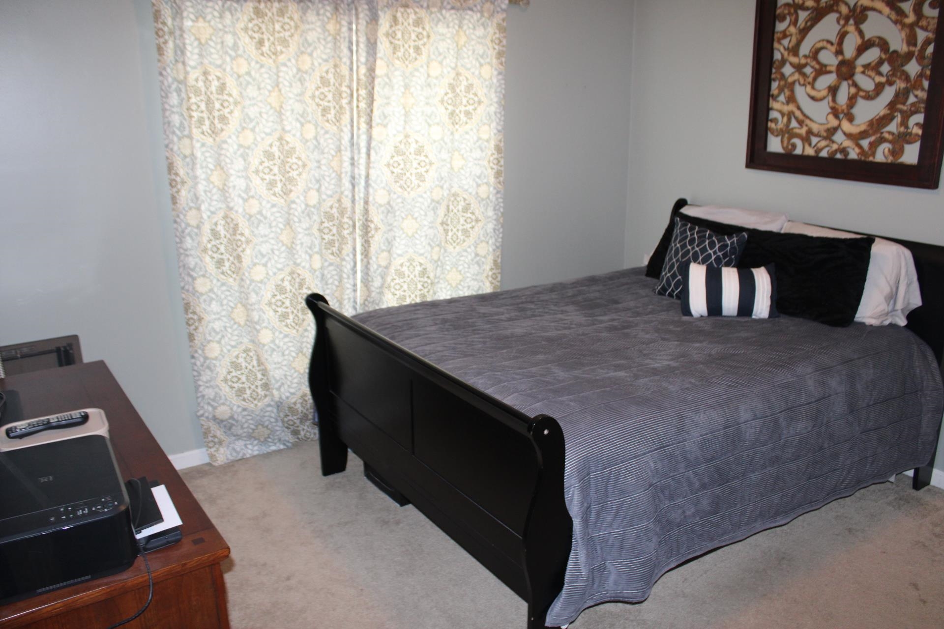 64 Buck Stand Road Atoka, TN 38004 - Photo 25 of 39 a bed sitting in a bedroom next to a window