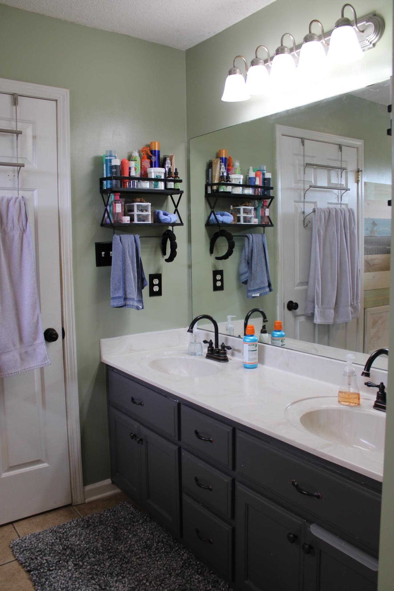 64 Buck Stand Road Atoka, TN 38004 - Photo 32 of 39 a bathroom with a double vanity sink and a mirror