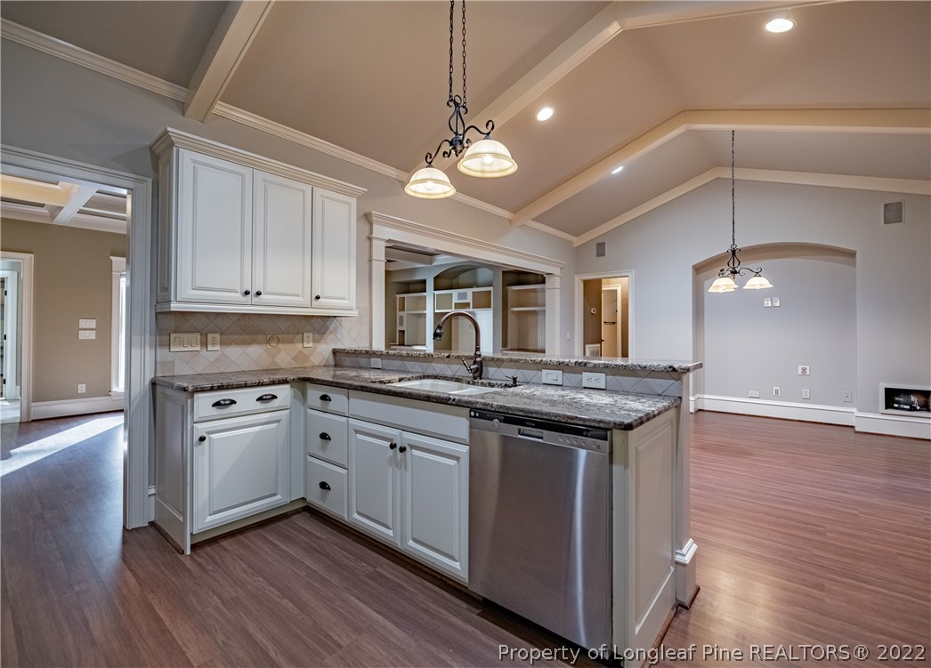 1305 Linden Road Aberdeen, NC 28315 - Photo 8 of 50 a kitchen with stainless steel appliances granite countertop wooden floors and granite counter tops