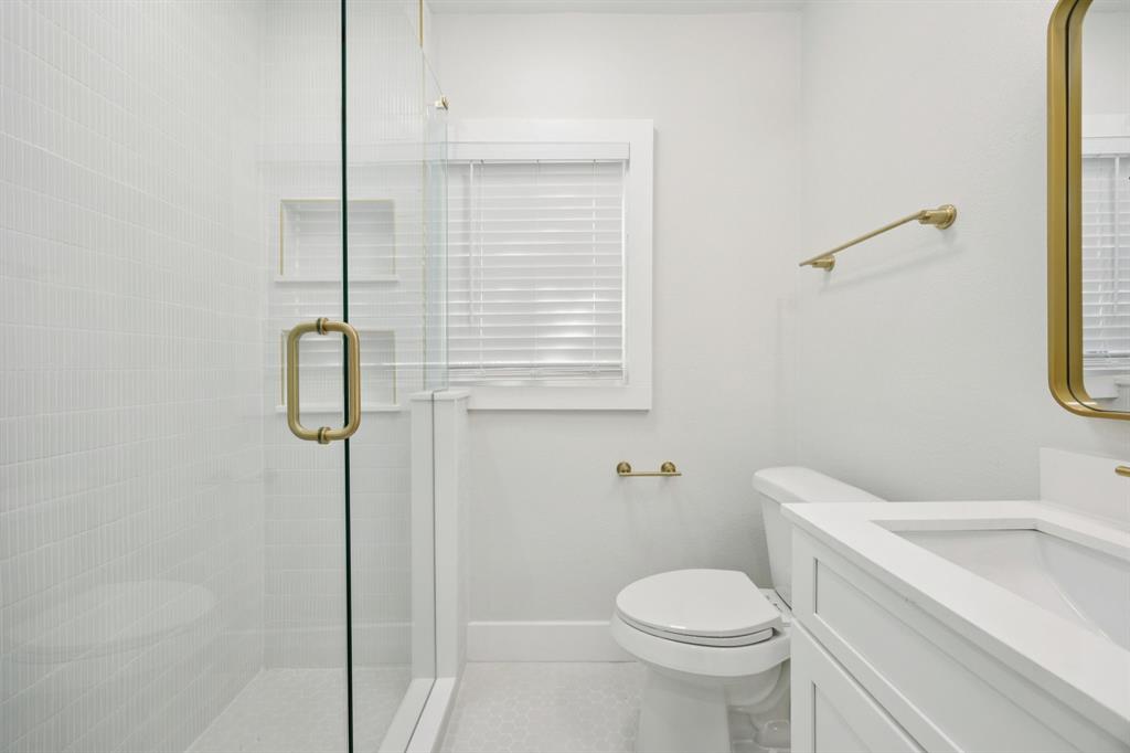 3210 North Haskell Avenue Dallas, TX 75204 - Photo 15 of 20 a white toilet sitting next to a bathroom sink