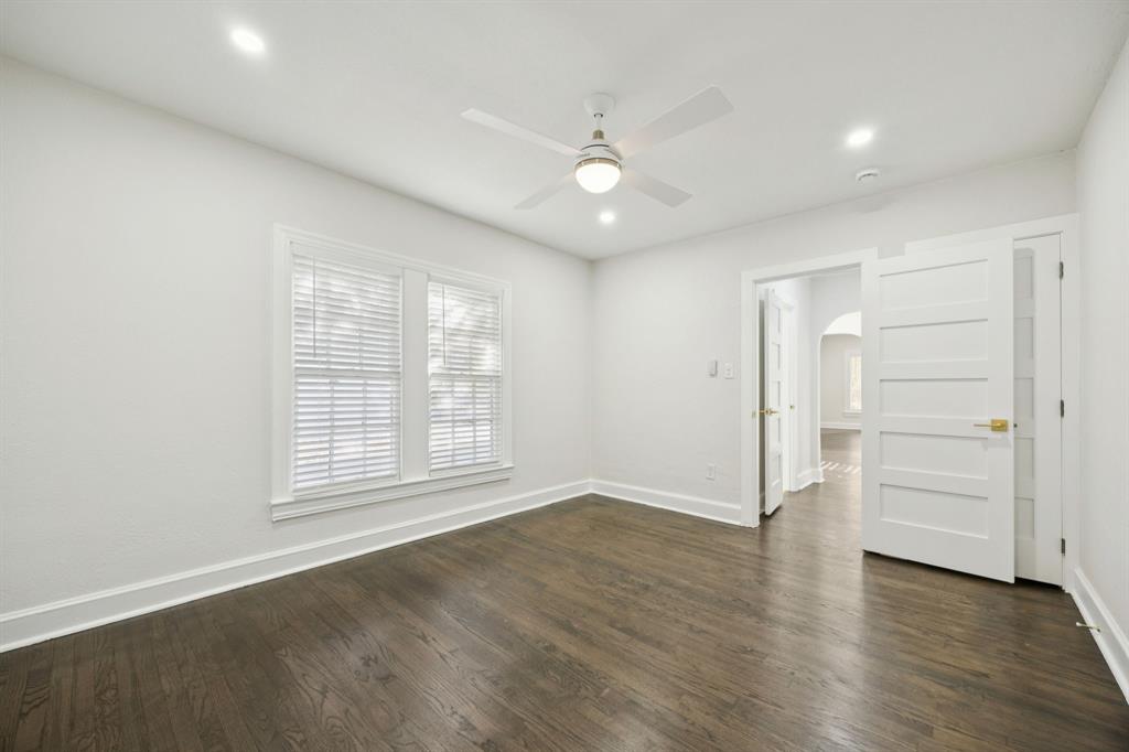3210 North Haskell Avenue Dallas, TX 75204 - Photo 17 of 20 an empty room with wooden floor cabinet and windows
