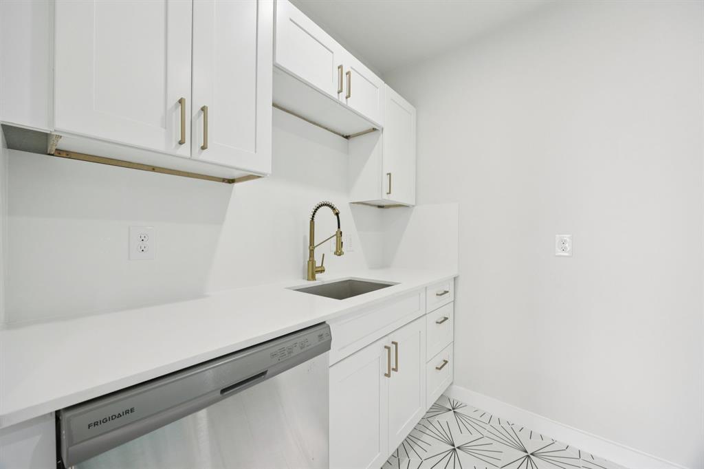 3210 North Haskell Avenue Dallas, TX 75204 - Photo 10 of 20 a kitchen with white cabinets a sink and dishwasher