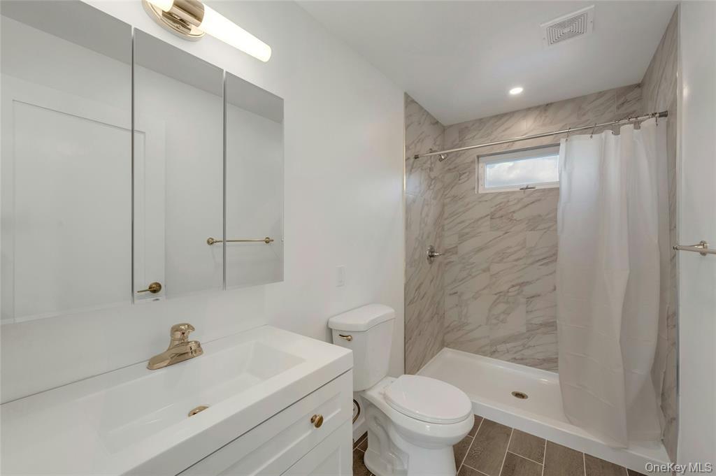 150 Bedford Road Armonk, NY 10504 - Photo 9 of 15 Bathroom featuring a stall shower and vanity