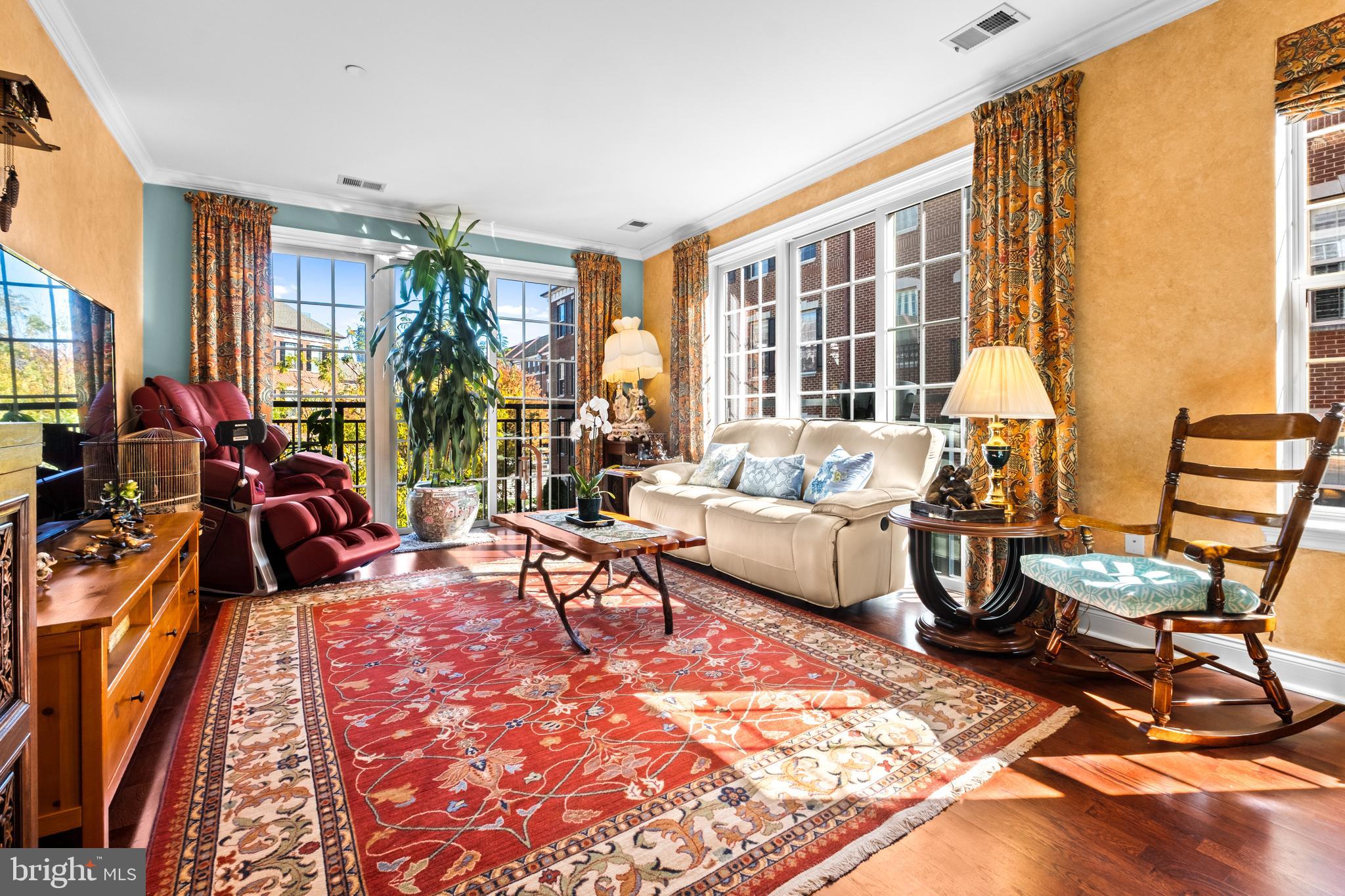 a living room filled with furniture hardwood floor and a large window