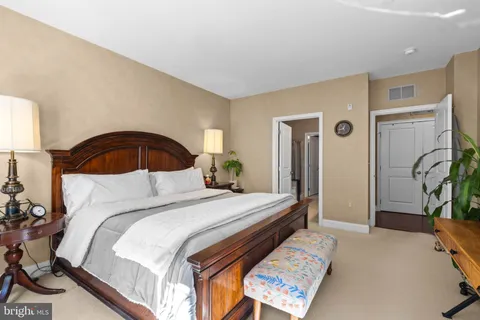 a bedroom with a bed and a potted plant