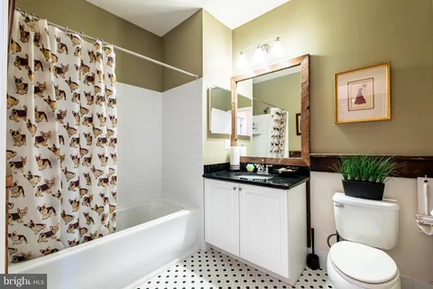 a bathroom with a sink toilet a mirror and shower