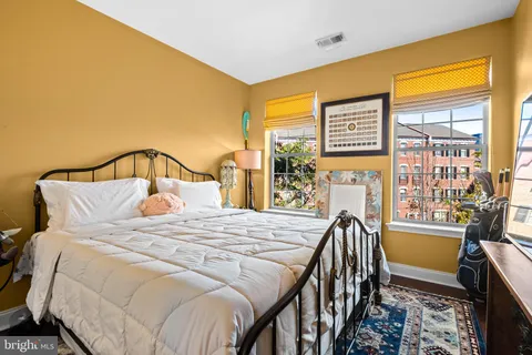 a bedroom with a bed next to a window