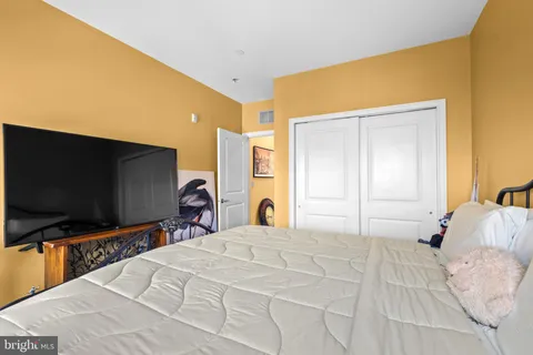 a bedroom with a bed and a flat screen tv