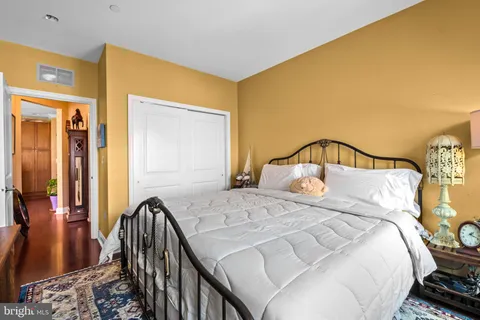 a bedroom with a bed and wooden floor