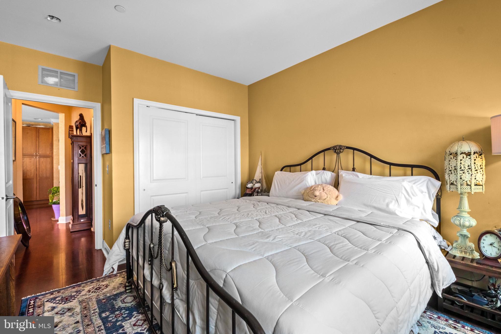 600 Commodore Court, Unit 2631 Philadelphia, PA 19146 - Photo 27 of 45 a bedroom with a bed and wooden floor