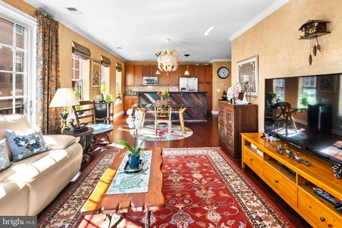 a living room with lots of furniture and wooden floor