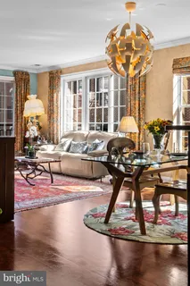 a living room filled with furniture gym equipment and a chandelier