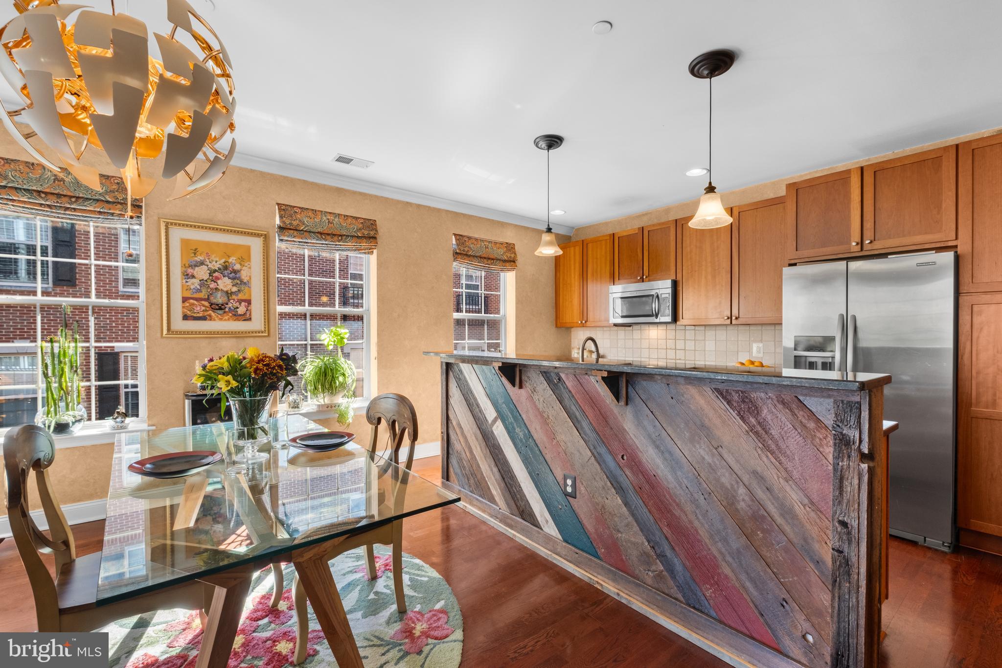 600 Commodore Court, Unit 2631 Philadelphia, PA 19146 - Photo 9 of 45 a view of a dining room with furniture a chandelier and wooden floor