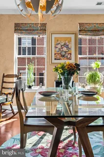 a view of a dining room with furniture a rug and wooden floor