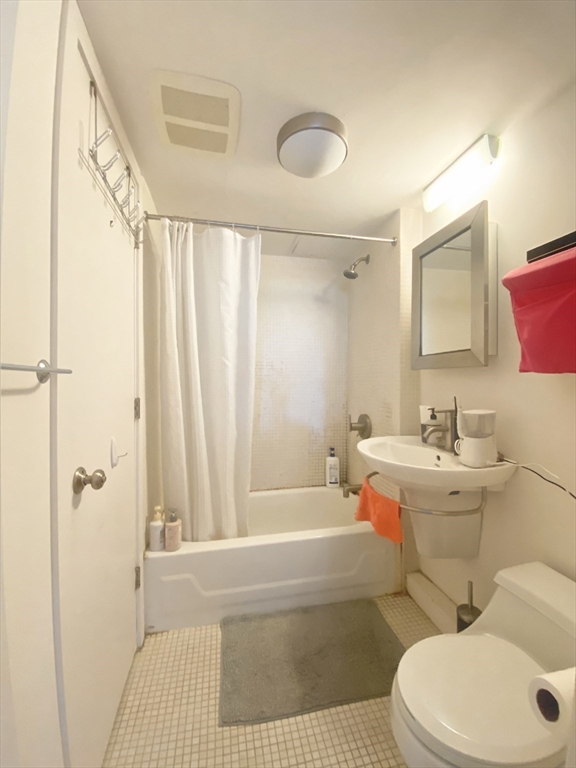 345 Harvard Street, Unit U1F Cambridge, MA 02138 - Photo 11 of 19 a bathroom with a sink toilet and shower