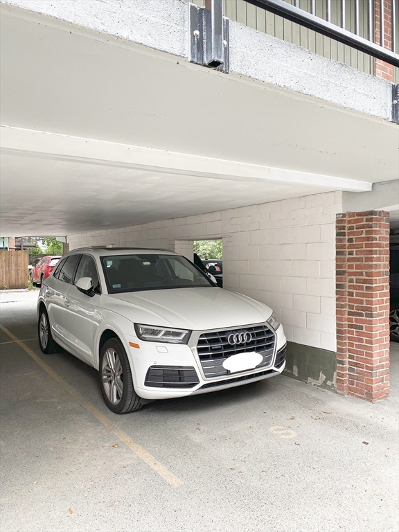 345 Harvard Street, Unit U1F Cambridge, MA 02138 - Photo 18 of 19 a car parked in parking