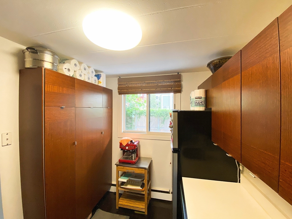 345 Harvard Street, Unit U1F Cambridge, MA 02138 - Photo 2 of 19 a bathroom with a bathtub and a window
