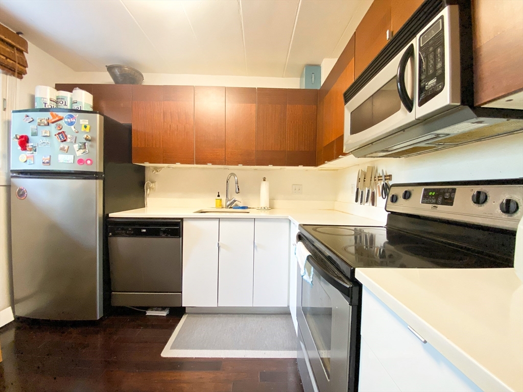 345 Harvard Street, Unit U1F Cambridge, MA 02138 - Photo 3 of 19 a kitchen with a refrigerator and a stove