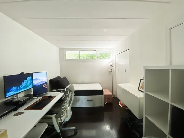 a bedroom with a bed and a desk