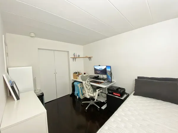 a bedroom with a bed and a desk