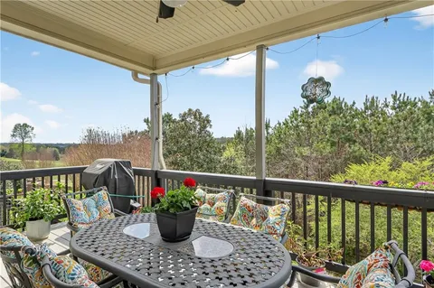 a view of a patio with table and chairs and potted plants