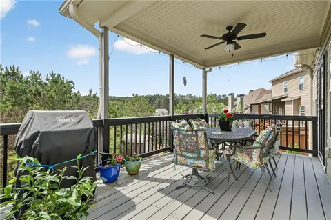 a view of a porch with furniture and a yard