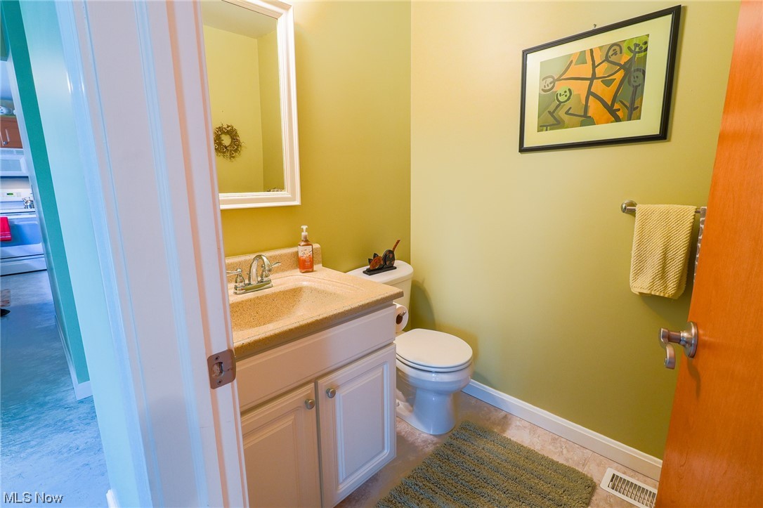 533 Middle Road Conneaut, OH 44030 - Photo 14 of 46 Bathroom with toilet, vanity, and tile flooring