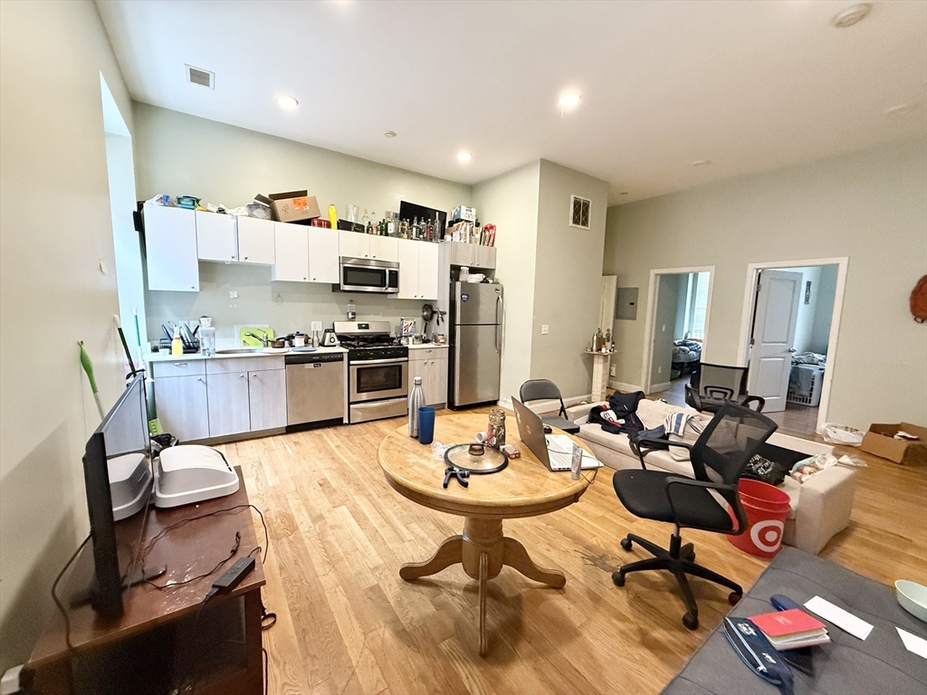 409 Dudley Street, Unit 3 Boston, MA 02119 - Photo 1 of 6 a living room with lots of furniture and kitchen view