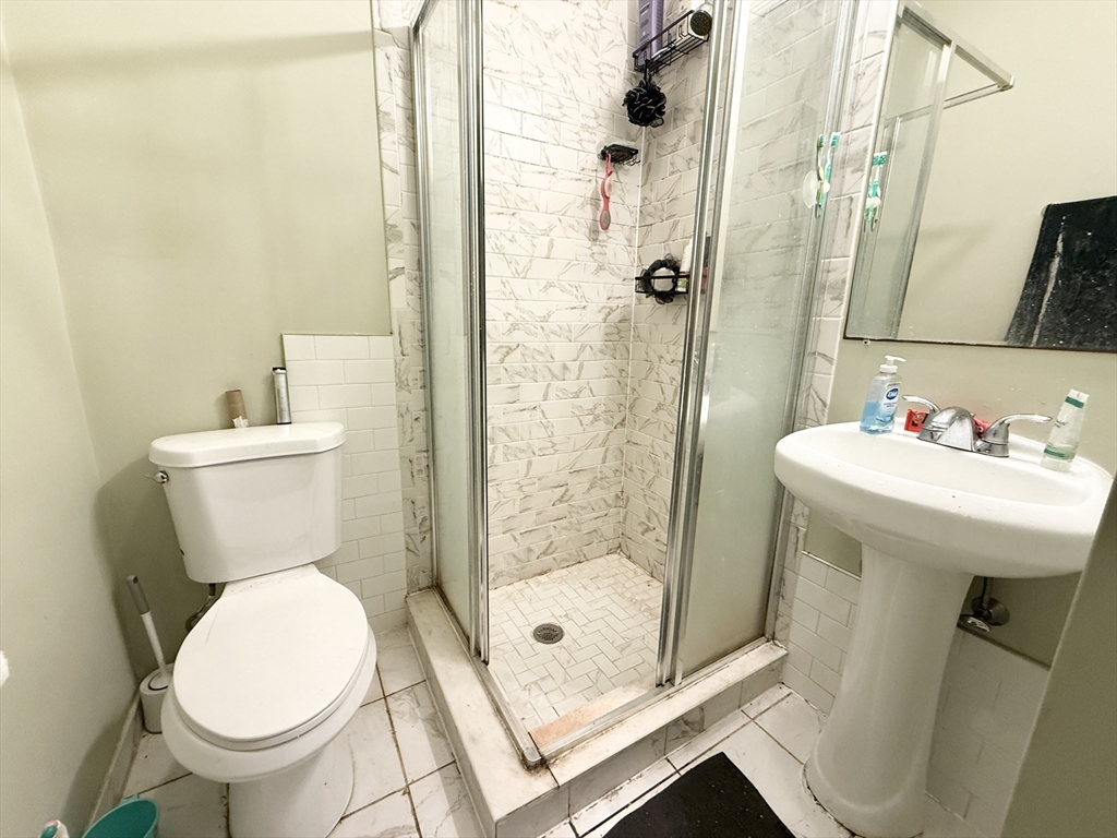 409 Dudley Street, Unit 3 Boston, MA 02119 - Photo 6 of 6 a bathroom with a sink toilet and shower