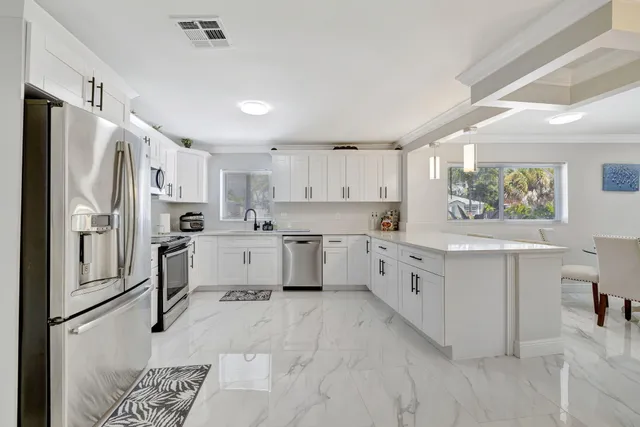 a bathroom with a double vanity sink a toilet and a shower