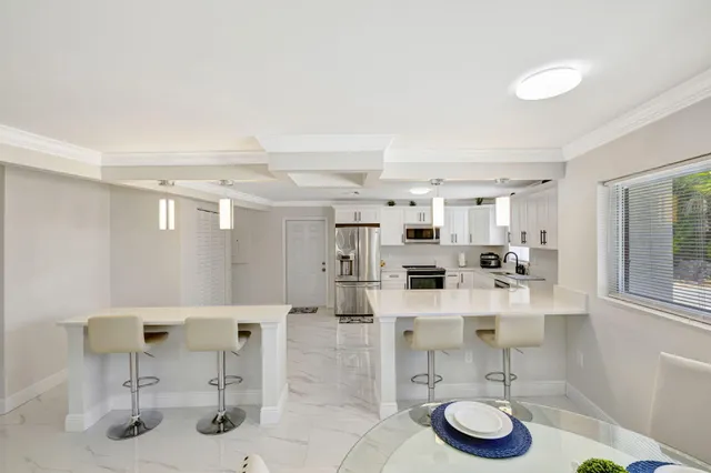 a bedroom with a large bed and a ceiling fan