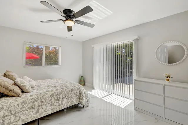 a bedroom with a bed and ceiling fan