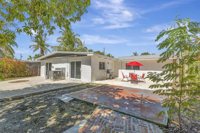 a view of a patio with a table and chairs under an umbrella