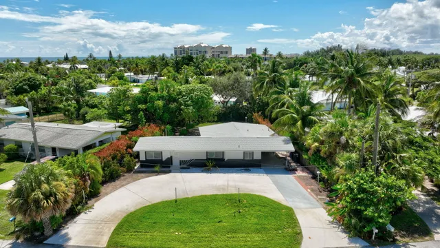 an aerial view of a house with swimming pool and a yard