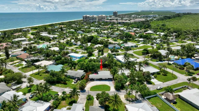 an aerial view of a house with a lake view