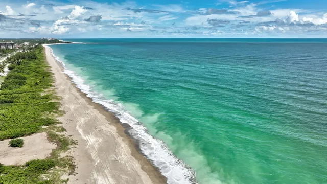 an aerial view of a residential houses with outdoor space and street view