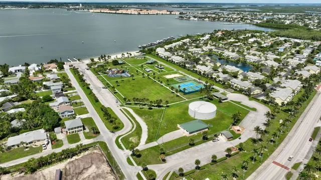 an aerial view of a pool a yard with chairs