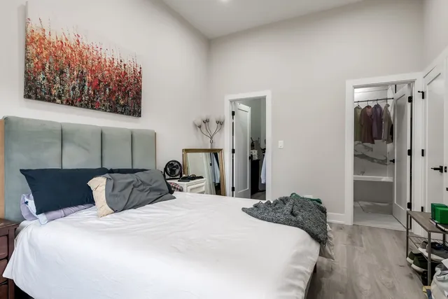 a bedroom with a bed and wooden floor