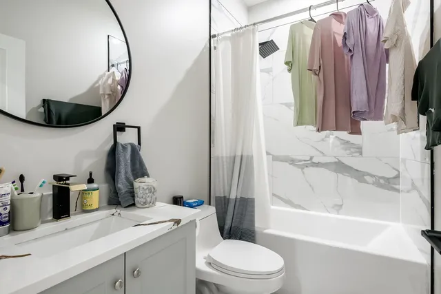 a bathroom with a sink a toilet and a mirror