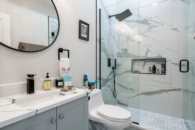 a bathroom with a toilet a sink and mirror